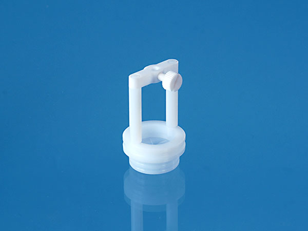 Holder for sample probe made of TFM